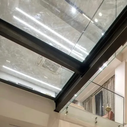 A view of the glass floor bridge in the Kedia's Residence. This architectural feature allows natural light to penetrate deeper into the home and creates a thrilling sense of transparency between floors.