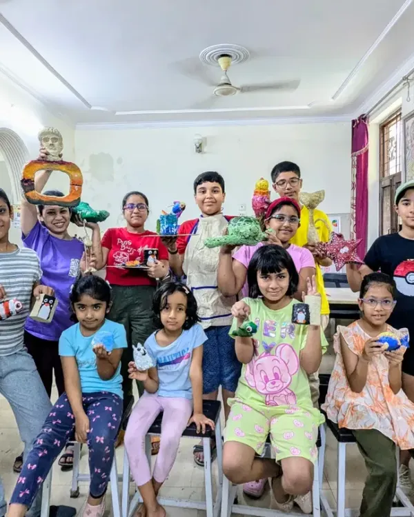 A happy group of young creators from my Saturday Junior Batch showing off their finished papermache sculptures. Look at the variety, from turtles and fish to abstract shapes.