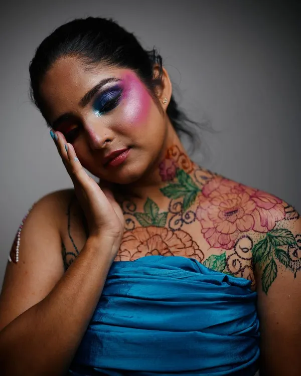 This photo from a creative collaboration shows a large floral henna piece on the chest and shoulder, brought to life with vibrant, skin safe colored henna. It's a perfect example of how henna can be used for editorial and artistic photoshoots.