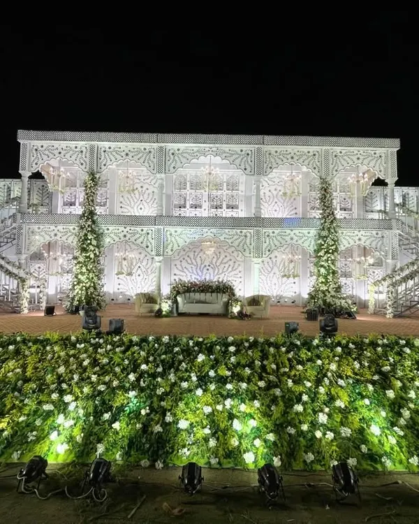 This is the kind of grandeur I love to create. A majestic, multi-level palace facade, intricately detailed and lit to perfection, serves as a breathtaking backdrop for a royal wedding reception.