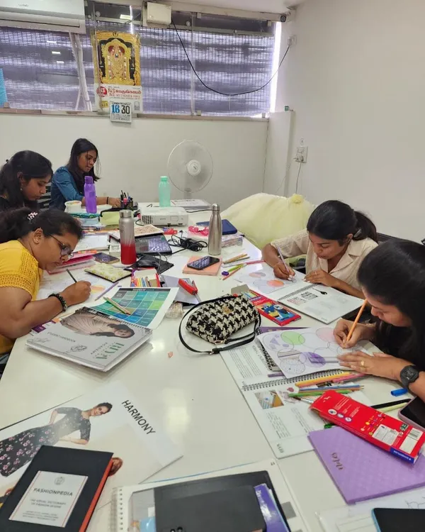 A typical day at the academy, with students fully immersed in a practical session. Here, they are working on color theory and illustration, bringing their design concepts to life on paper.