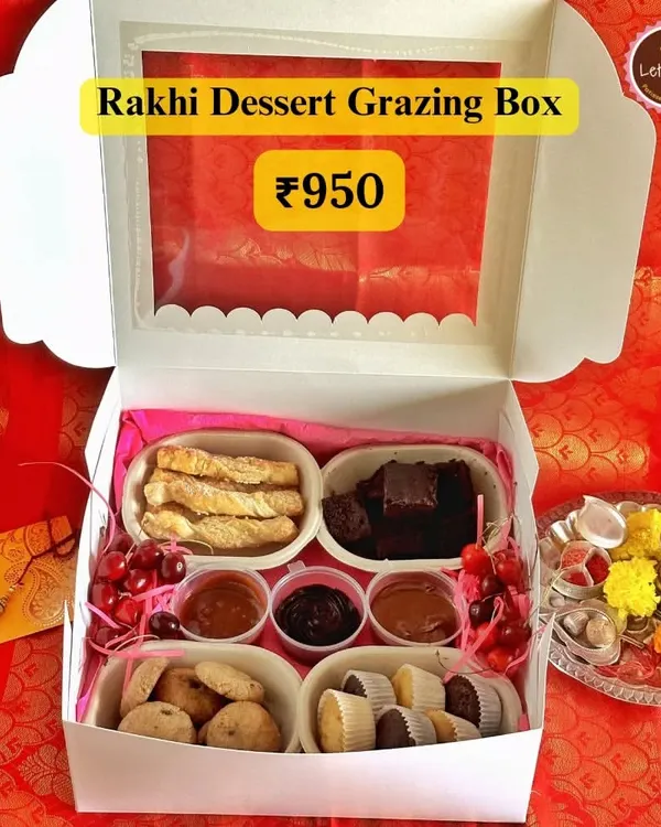 My Rakhi Dessert Grazing Box is perfect for sharing. It’s filled with an assortment of treats like palmiers, brownies, cookies, mini cupcakes, and three different dessert dips.