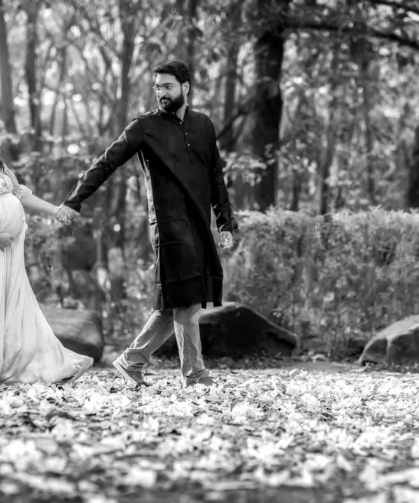 A romantic walk in the park. This beautiful shot captures a quiet moment between the expecting couple. We help you choose the perfect gown to match the mood of your shoot.
