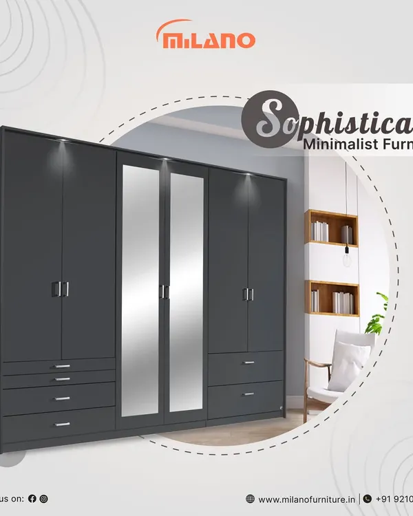 This sophisticated minimalist wardrobe features a dark grey finish, clean lines, and integrated mirrored panels. With ample drawers and hanging space, it's a stylish and practical storage solution for a modern bedroom.
