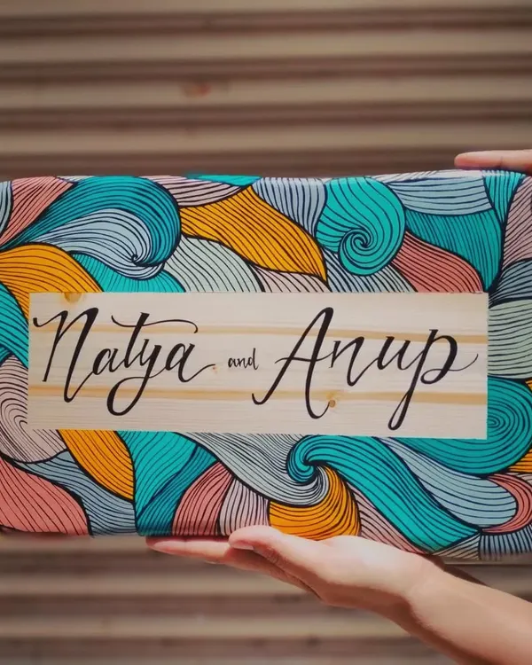 We love how this boho-inspired name plaque for "Natya and Anup" turned out. The natural wood grain in the center contrasts beautifully with the colorful, intricate line art, all painted by hand.