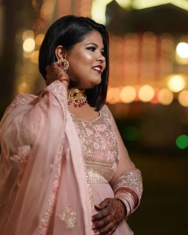 This is a candid shot from a wedding I attended. I did my own makeup with a classic smokey eye and a bold red lip. I believe you should always feel confident and beautiful, ready to stand out. 💕