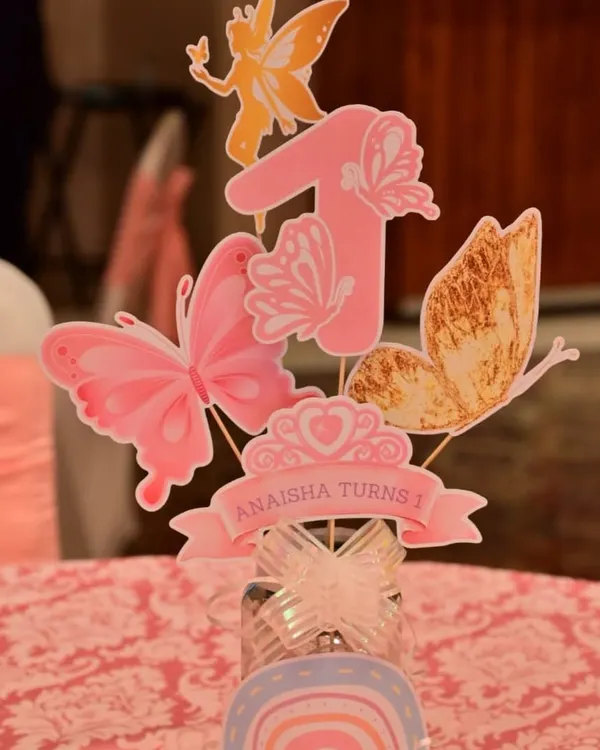 A close-up of a beautiful centerpiece for Anaisha's first birthday. This custom-made piece features the number '1' adorned with delicate paper butterflies, perfectly matching the enchanted garden theme.