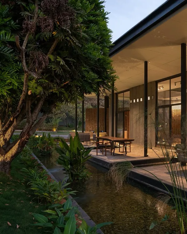 At dusk, 'The Earth' experience center glows with warmth, its lightweight MS frame and dry-clad granite walls settling into the landscape. The design is a beacon of sustainable architecture, blending modern techniques with timeless materials.