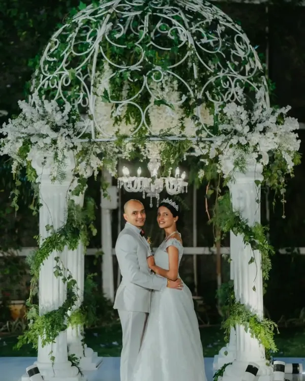 A fairytale moment captured under a beautiful white gazebo adorned with flowers and greenery. I create these classic, romantic settings for your perfect "I do".