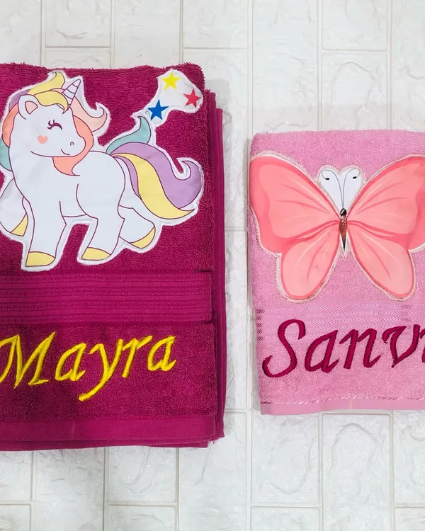 Make bath time more fun with a personalized towel. Here are two I made: a vibrant magenta towel with a unicorn for Mayra, and a soft pink one with a butterfly for Sanvi.