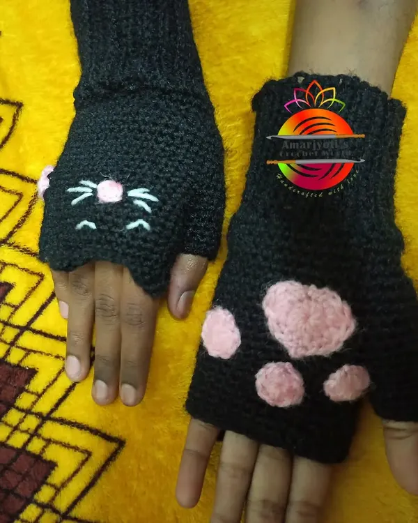 My cat paw fingerless gloves are a favorite. One glove features an embroidered cat face, and the other has appliqued pink paw prints, making them a purr-fectly charming set.