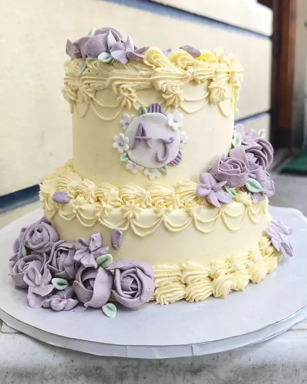 This two-tier vintage engagement cake is one of my absolute favorites. I find the process of creating these intricate buttercream piped details and delicate lavender roses so therapeutic, and the result is a timeless centerpiece.