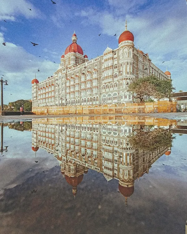A classic reflection of the Taj Mahal Palace hotel in a monsoon puddle. This shot captures the grandeur of Mumbai's heritage architecture, a recurring theme in my work.