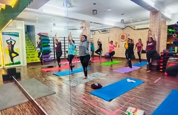 A full house for our morning group yoga session. You can see the energy as everyone holds the tree pose, finding their balance together in our spacious, mirrored studio.