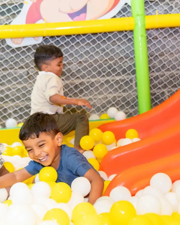 Pure, unfiltered joy is a cornerstone of our play-based learning. Here, a child's laughter in our colorful ball pit captures the essence of a happy day at Cubby Tales, where fun and development go hand in hand in our safe indoor play zones.