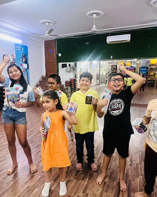A happy group of kids celebrating with their prizes after a workshop. This is what our community is all about: learning, having fun, and cheering each other on.