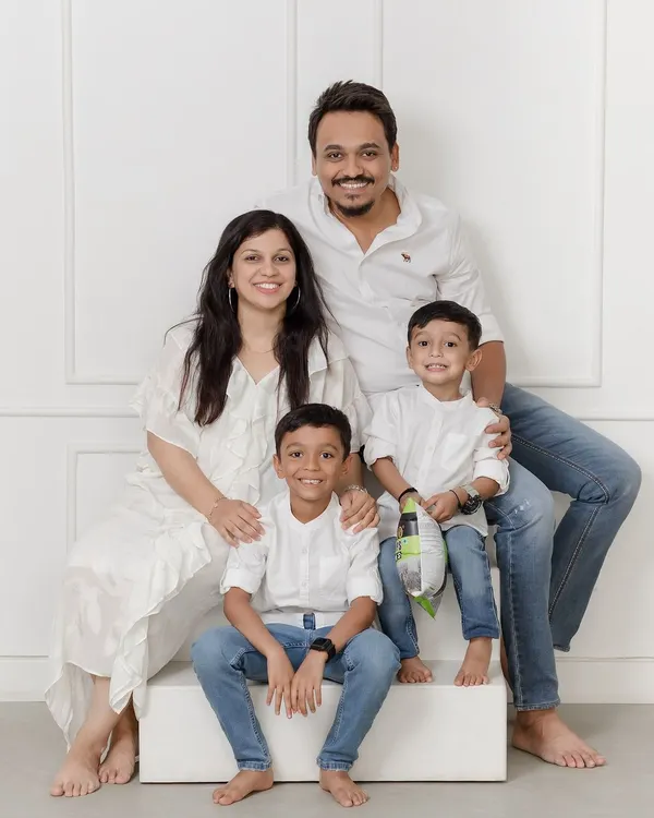 A beautiful family of four dressed in classic white and denim. This timeless style allows the family's connection and joy to be the true focus of the portrait.