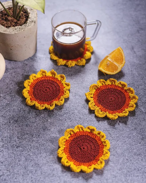Our sunflower coasters bring sunshine to any table setting. This lifestyle shot shows how a set of four can brighten up your coffee time while keeping your surfaces clean from water rings.