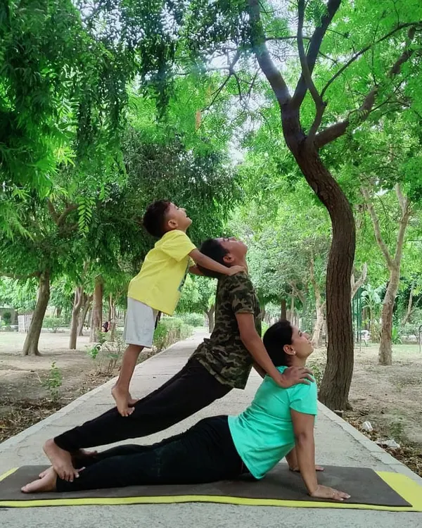 For me, fitness is all about family, fun, and finding strength together. Here we are doing a family acro yoga pose in the park, showing that movement can be playful and a great way to bond.