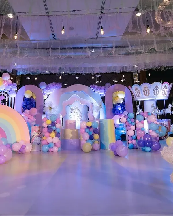 A full view of our unicorn theme setup, featuring multiple custom arches, a carousel, and a floor-to-ceiling balloon installation. We design every element to create a complete, immersive party experience.