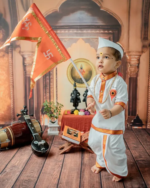 This 'Chota Varkari' theme is one of my specialties, celebrating Maharashtrian heritage with authentic details. Here, the little one stands proudly with the saffron flag, creating a powerful and timeless portrait.