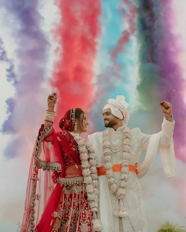 A truly epic varmala moment. I framed the couple against a backdrop of colorful smoke, creating a vibrant and unforgettable image that perfectly captures the joy and energy of their union.