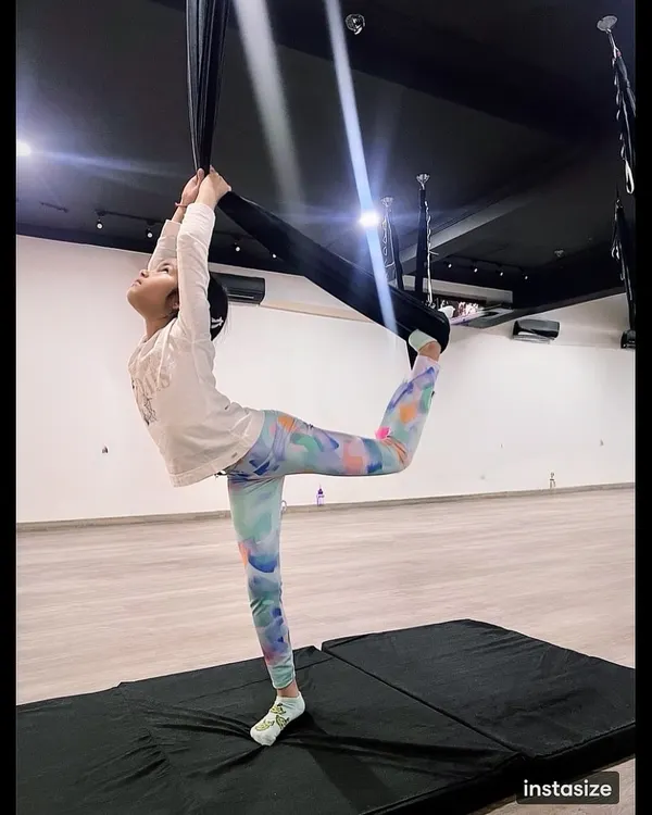 This is the magic of aerial yoga. We see our little yogis find their grace and strength, holding poses with a confidence that shines. This beautiful dancer pose in the hammock is a testament to focus and practice.