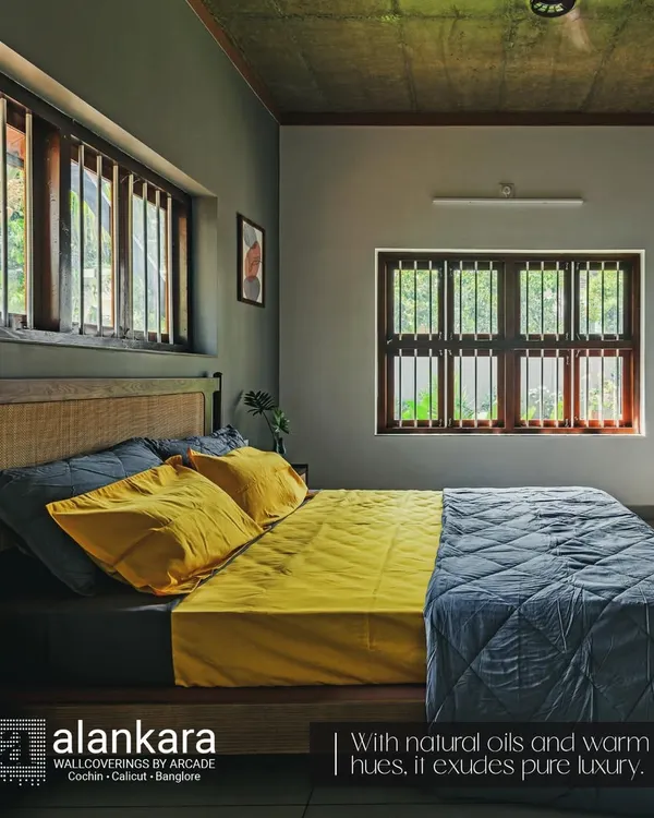 This custom bed features a headboard with a natural cane weave panel, set against a dark grey wall for a dramatic effect. The vibrant yellow and grey bedding adds a modern, cheerful touch.