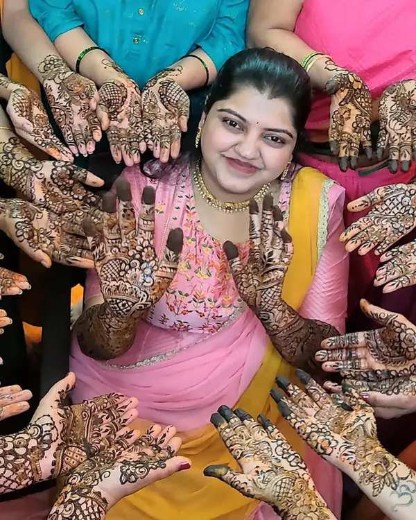 A classic mehendi party photo. I love capturing this moment with the bride surrounded by her friends and family, all showing off their beautiful henna designs.