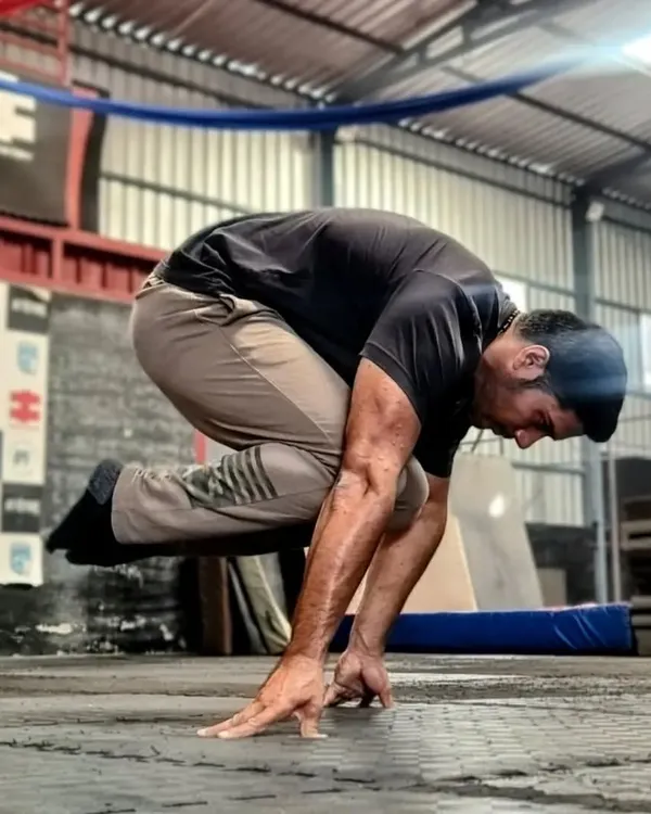 A clear shot of the tuck planche. This is where the journey begins. Mastering this position builds the foundational strength and wrist conditioning needed for all planche variations.