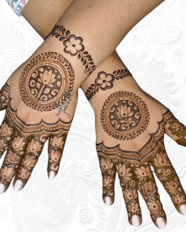 A beautiful and balanced backhand design featuring a lotus mandala in the center with a simple floral bracelet.