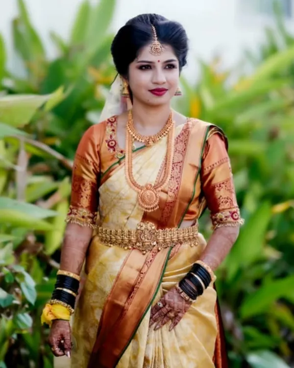 A classic South Indian bridal portrait. This look features a beautiful Kanjeevaram saree, traditional gold temple jewellery, and a bold red lip for a timeless finish.