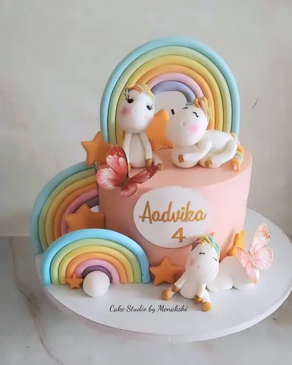 This absolutely stunning unicorn themed cake was handcrafted with love for a 4th birthday. It features multiple rainbows and adorable unicorn figures, all made from fondant to create a magical scene.