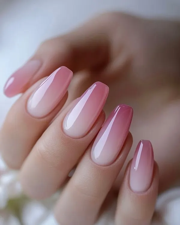 A perfect example of a pink and white ombre, or "baby boomer" nail. The seamless blend of color on this elegant coffin shape is a classic and popular choice.