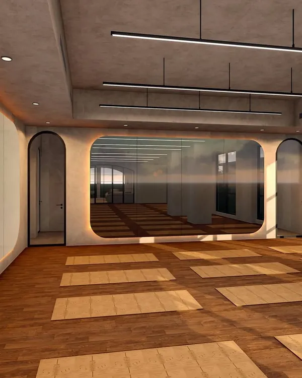 This is a view of the main yoga hall at Ignite + Aliign Studio, where I used a combination of raw, textured walls and warm wood flooring. The design features soft, rounded corners and recessed cove lighting to create a gentle, enveloping atmosphere.