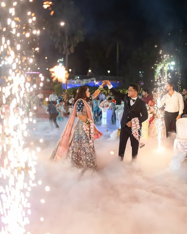 The couple's magical first dance at their reception, surrounded by sparklers and fog. I use these elements to create truly spectacular and memorable wedding reception photography.