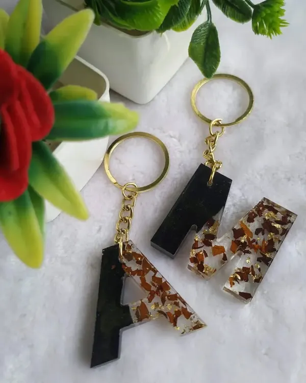 Matching initial keychains are a great couple's gift. Here, I preserved rose petals in a black and clear design for the letters 'A' and 'M'.