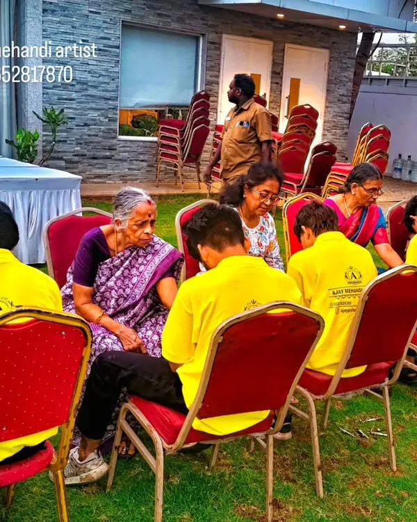 Our team of artists, all in uniform, working efficiently at an outdoor event. We set up to handle multiple guests at once, making the process smooth for large gatherings like weddings and sangeet parties.