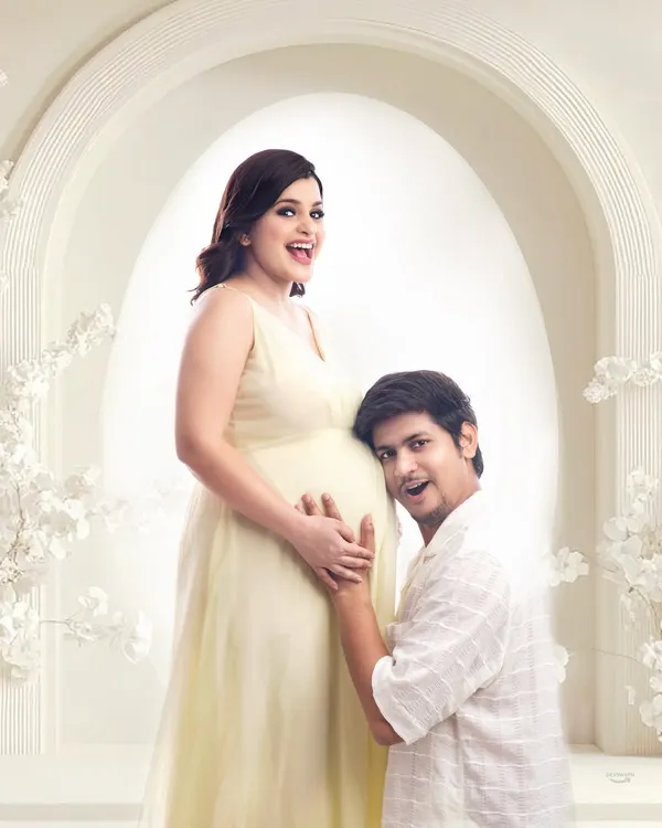 A sweet and playful moment as the dad-to-be listens to the baby bump. This is a classic couple pose that always brings out genuine smiles, captured here in my bright and airy studio.