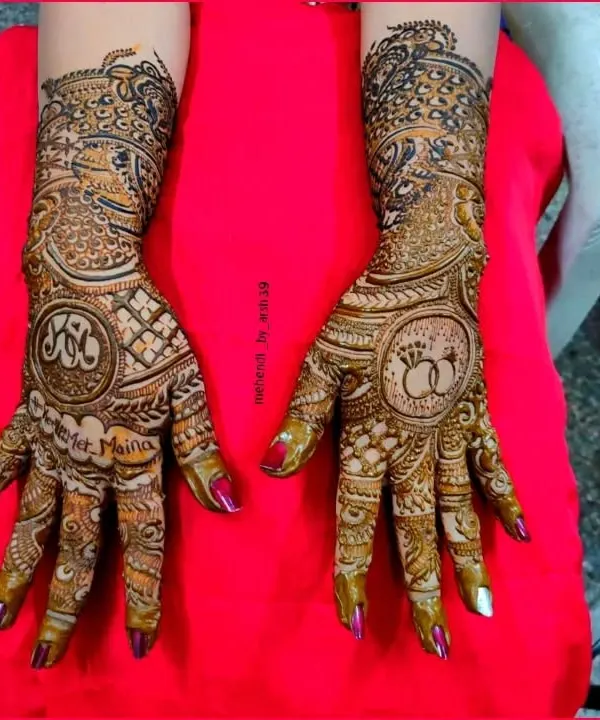 Your mehendi should tell your love story. Here, I incorporated the couple's initials and their engagement rings into the design, making it a truly personal piece of art for their special day.