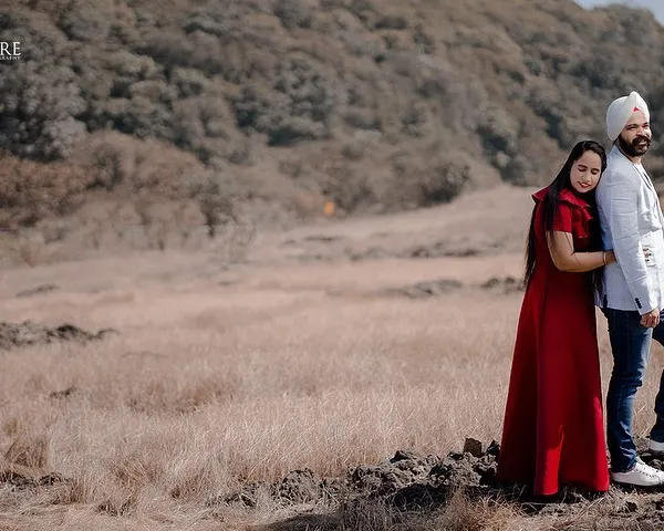 A quiet moment of togetherness for Karan and Simarpreet in a wide, open landscape. This photo emphasizes peace and intimacy, showing that love can be a calm and steady presence.
