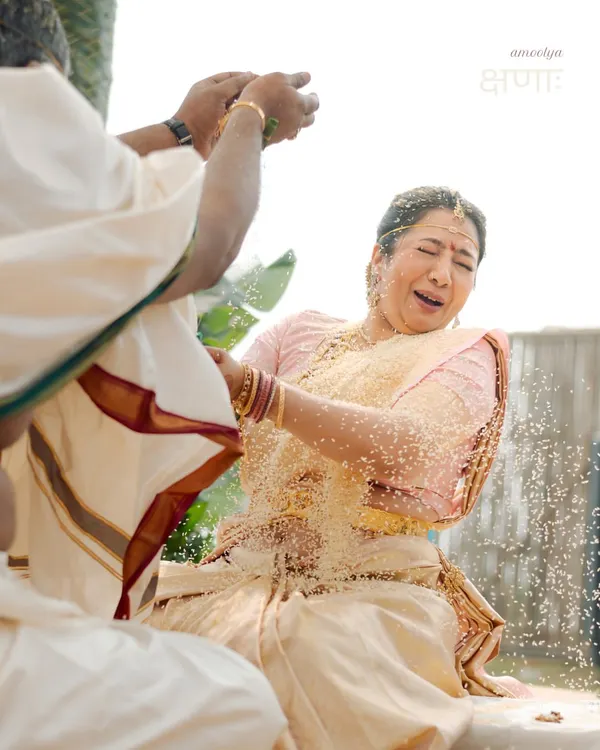 The Talambralu ritual in a South Indian wedding is a moment of pure, uninhibited joy. I captured the bride's wonderful reaction as she is showered with rice and pearls. This is a perfect example of a precious, candid moment, a true 'kshanaah amoolya'.