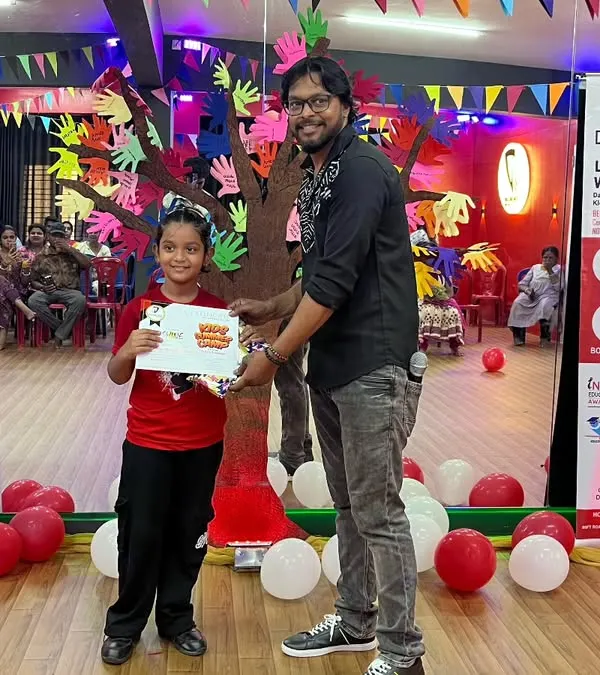 A proud camper receiving her certificate of appreciation at the April batch showcase. These moments are what make the camp experience so memorable.