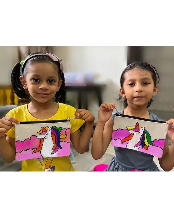 Two proud young artists show off the matching unicorn pouches they painted. Our pouch painting workshops are a hit, letting kids create a functional item to store their treasures.