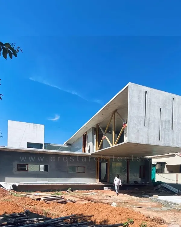The Long House under construction, showcasing the impressive 23-foot cantilevered volume. This image reveals the raw structural ambition before the application of finishing materials.