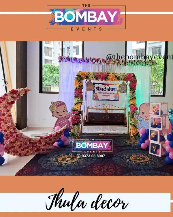 A beautiful Dohale Jevan decoration in a sunlit room, featuring a floral jhula, a crescent moon prop, and baby cutouts. This setup is perfect for daytime functions.