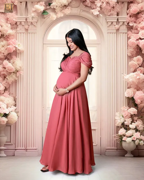 An example of our elaborate floral studio sets, featuring a grand doorway and arch covered in pink flowers.