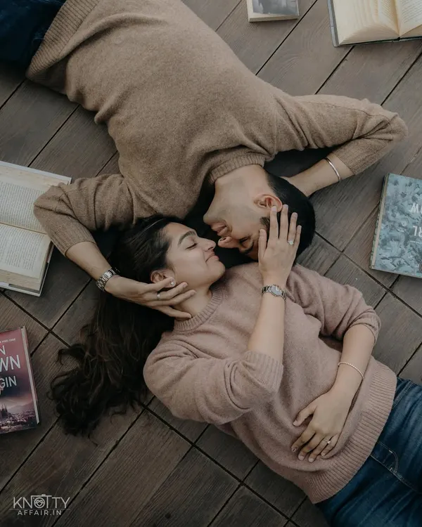 An overhead shot of a couple lost in their own world, surrounded by books. This creative angle provides a unique and intimate view of their connection.