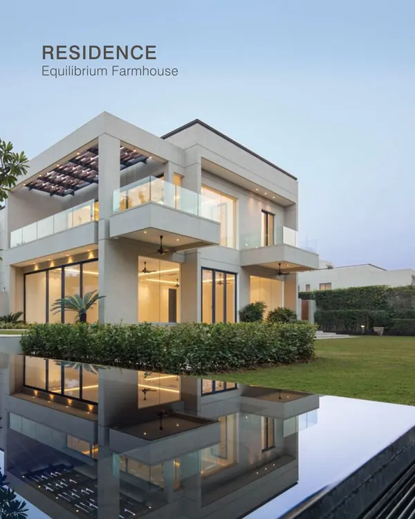 This modern farmhouse, reflected in the tranquil water, represents our ideal of equilibrium. We design homes that balance clean, contemporary aesthetics with a deep connection to the natural landscape, creating a serene retreat from the city.
