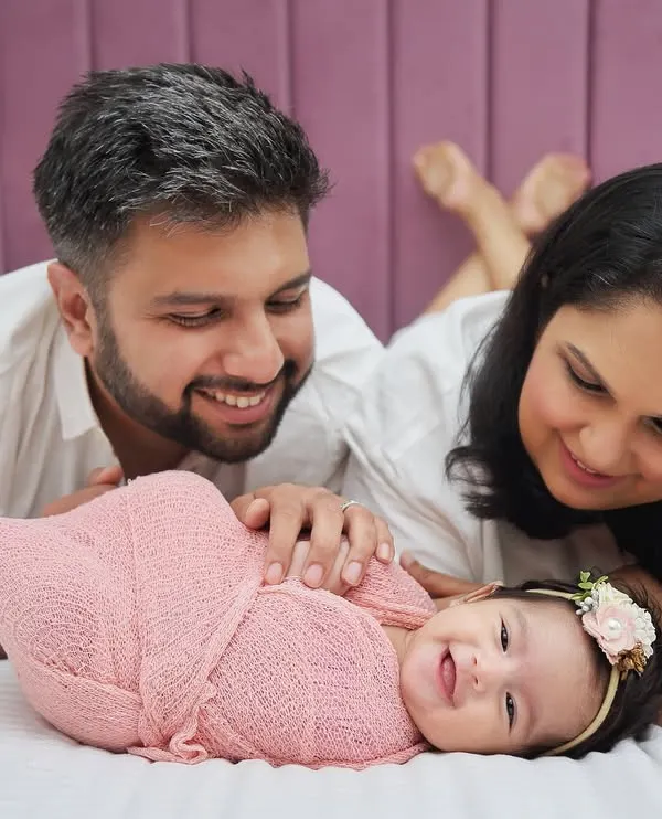 The pure joy of new parents admiring their baby. I focus on creating a relaxed space where these beautiful, unscripted moments can happen. This little one's smile made the whole session.
